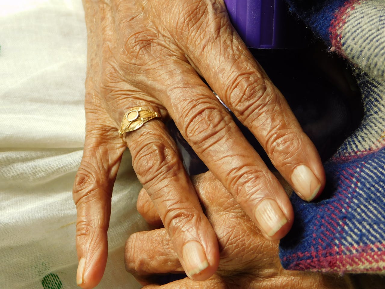 close-up-of-senior-hands-with-wrinkled-skin-and-ring-36730753